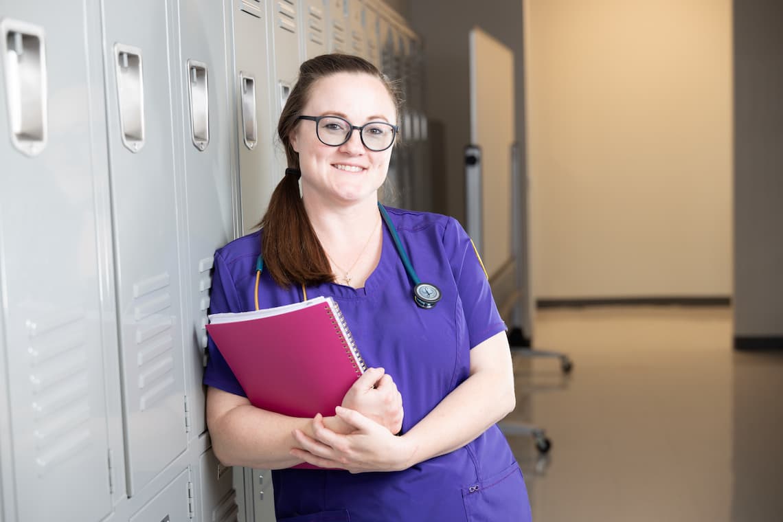 Nurse leaning against locker