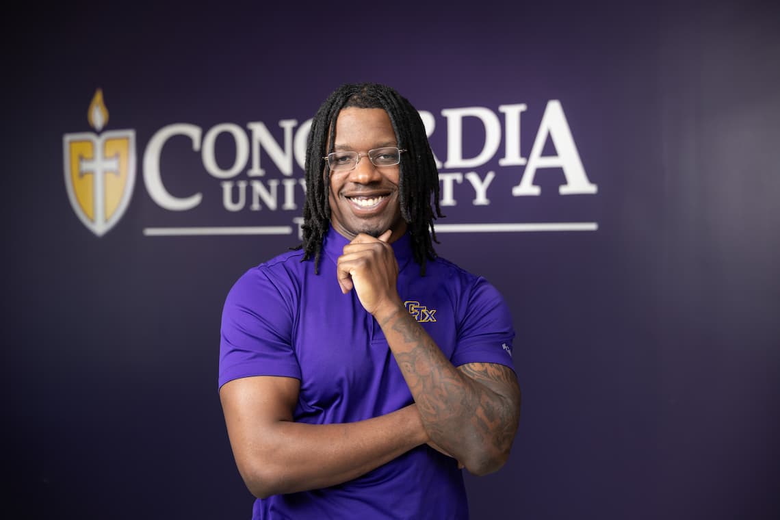 Nursing student posing in front of a wall